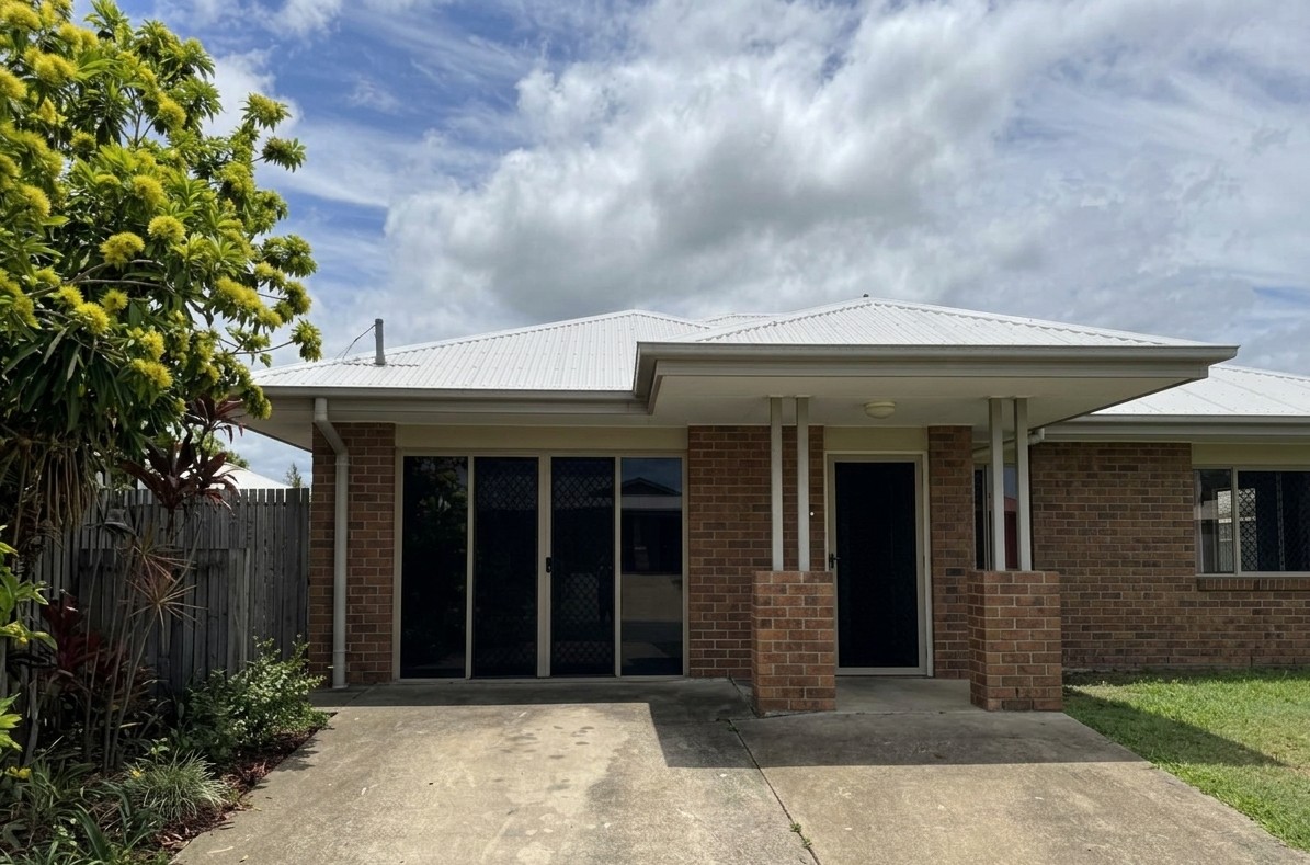 Front of warm and welcoming SIL home in Mackay, Inverness Ct, Beaconsfield, featuring brick exterior, covered porch, and greenery, part of Australia’s leading disability accommodation provider.