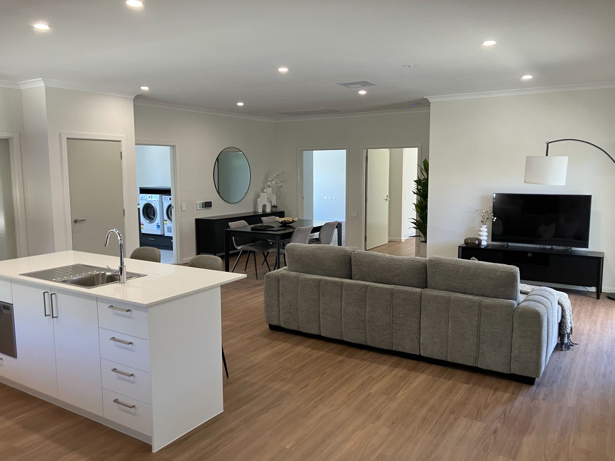 Kitchen island to the left, living area to the right and dining in the far left corner