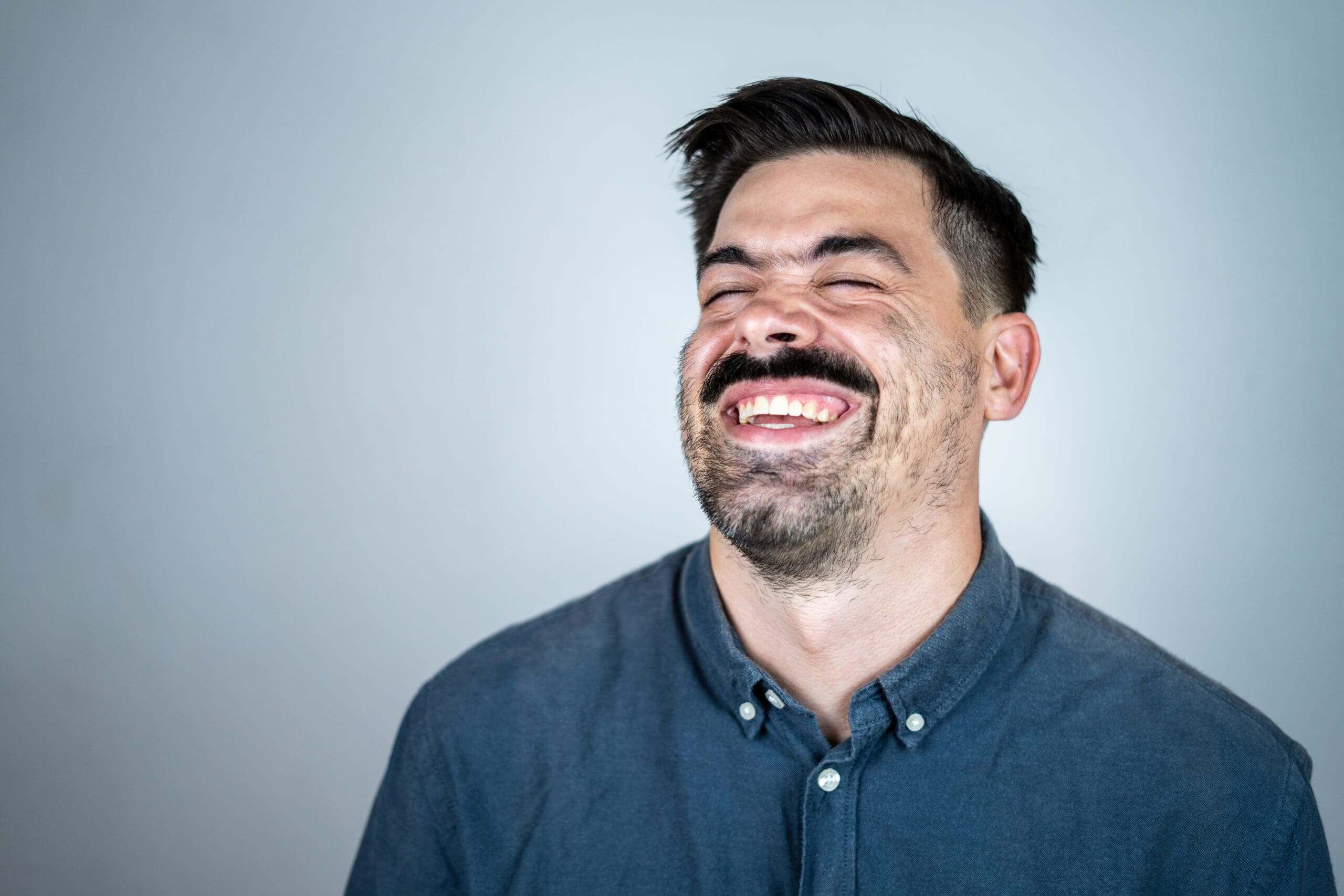 Midage man smiling with his eyes closed
