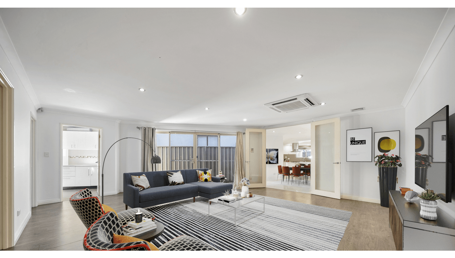 Modern, accessible living room in a Supported Independent Living (SIL) Home in Morley, Australia, featuring open-plan design, comfortable seating, and natural light, part of Australia’s leading disability accommodation provider.