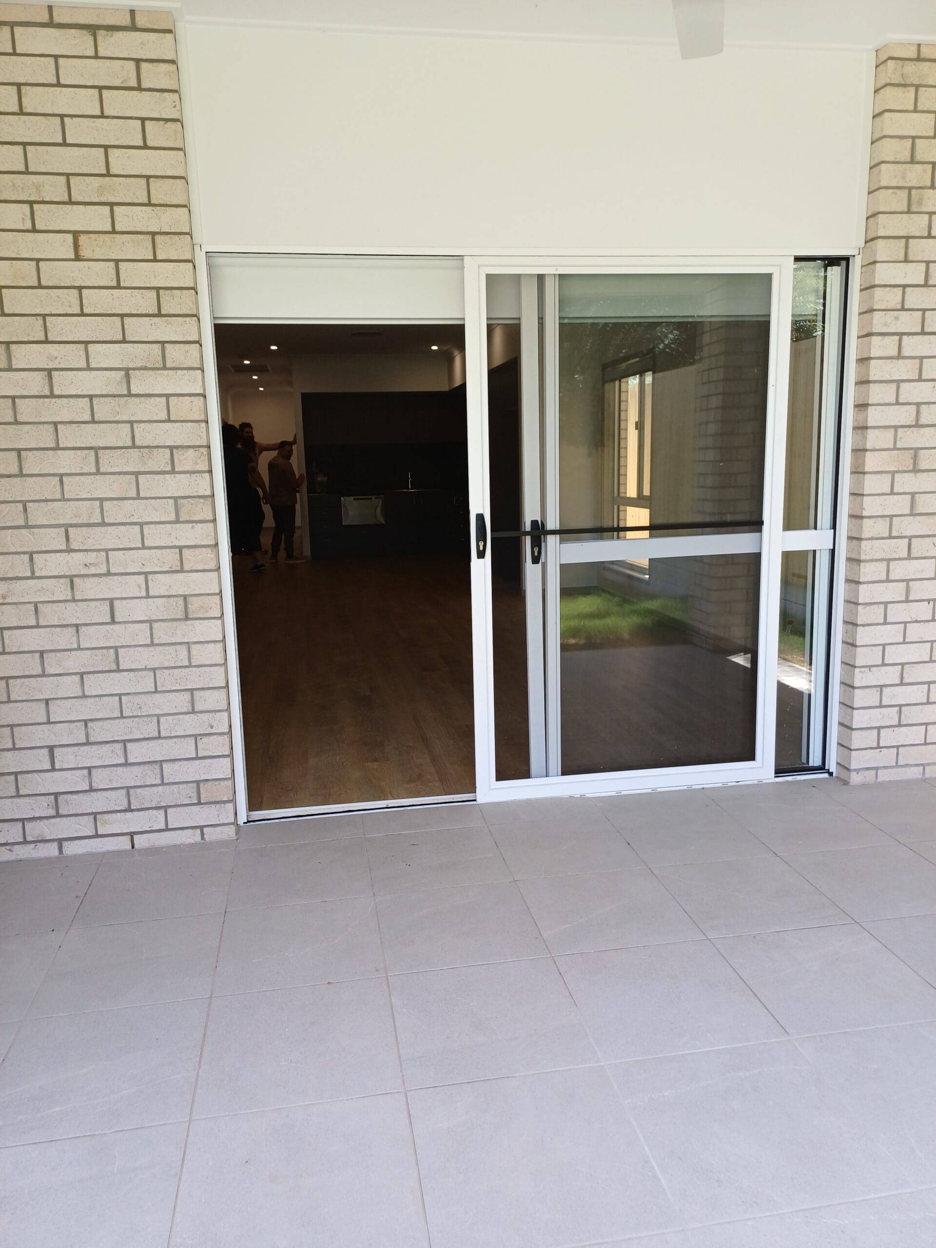 Accessible entryway and patio of Purpose-Built High Physical Support Living in Cleveland, Langdon Street, featuring wide sliding doors, level paving, and seamless indoor-outdoor flow, part of Australia’s leading disability accommodation provider.