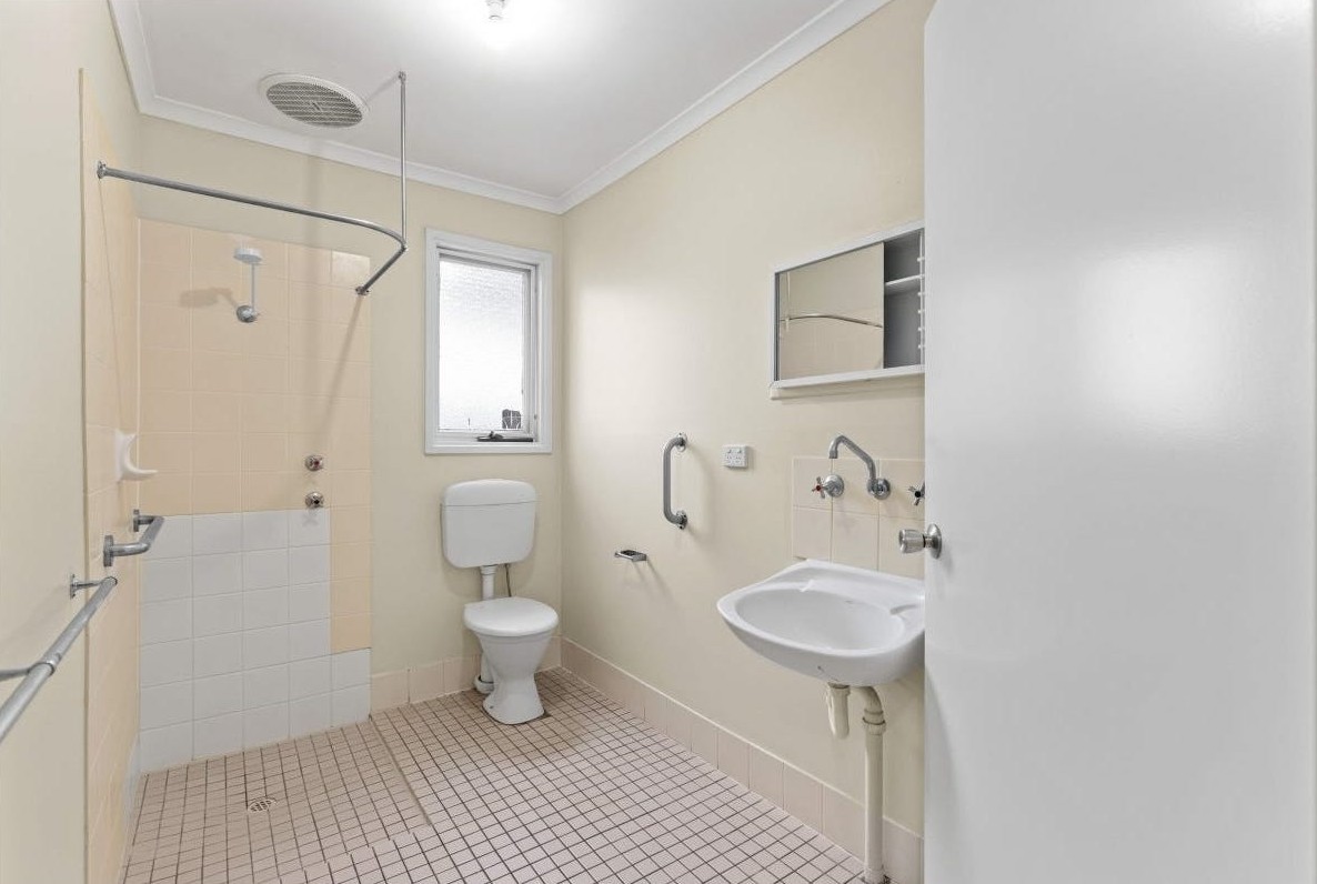 Functional, accessible bathroom in our Accessible unit in quiet Huntfield Heights, 2/11 Lorne Crescent, designed for safety and independence with grab rails, clear circulation, and natural light by Australia’s leading disability accommodation provider.
