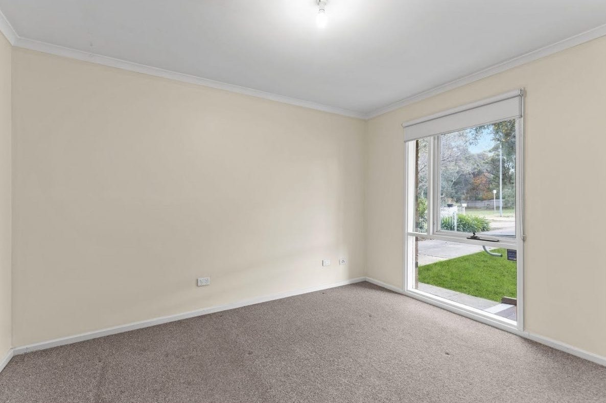 Accessible bedroom in Accessible unit in quiet Huntfield Heights, 2/11 Lorne Crescent, featuring neutral tones, large window, and clear circulation, part of Australia’s leading disability accommodation provider.