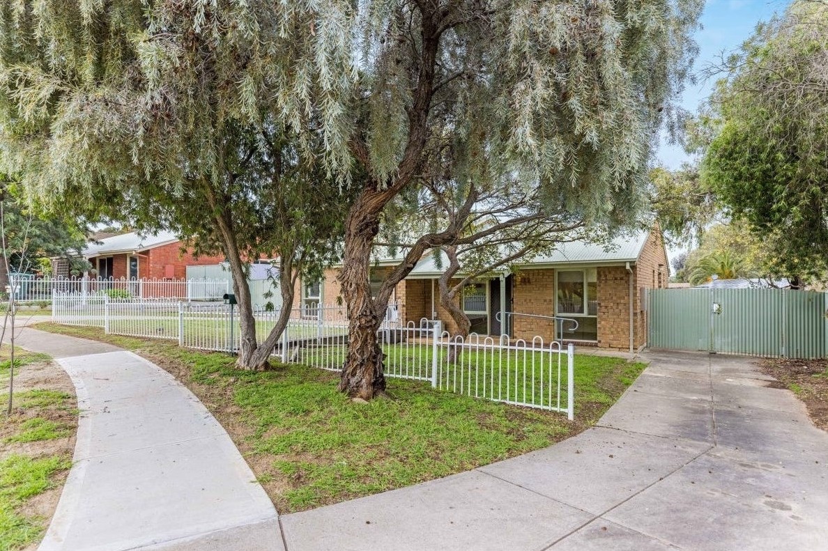 Front of the house: Accessible unit in quiet Huntfield Heights, 2/11 Lorne Crescent, featuring level pathway, mature trees, and secure fencing, part of Australia’s leading disability accommodation provider.