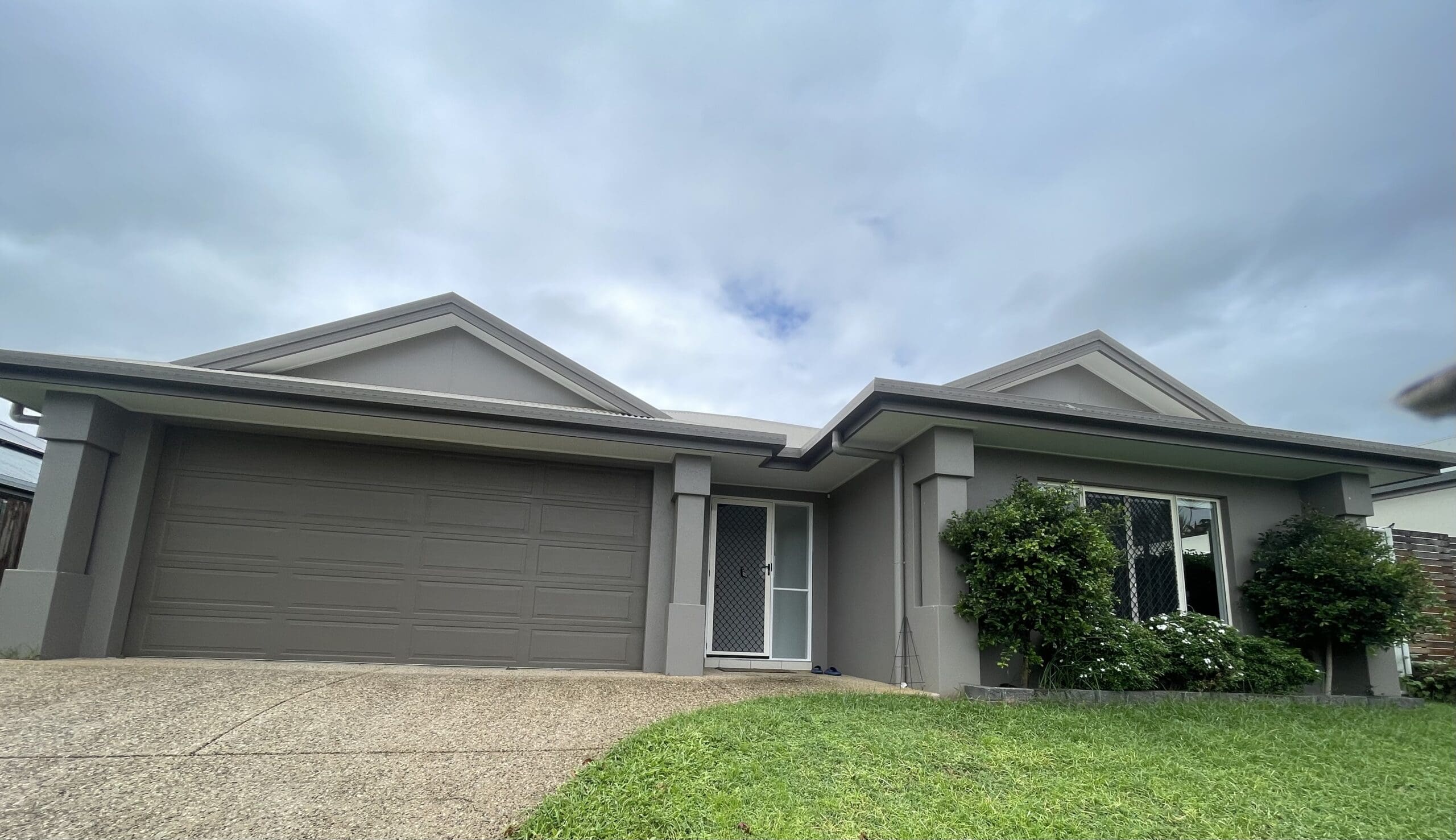 Frontage of Spacious SIL home in leafy 23 Norfolk Circuit, Redlynch featuring accessible entry, double garage, and landscaped garden, part of Australia’s leading disability accommodation provider.