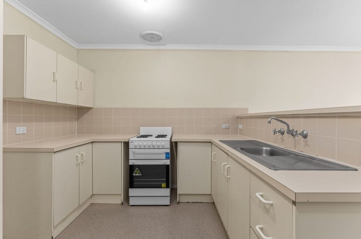 Accessible U-shaped kitchen in Accessible unit in quiet Huntfield Heights, 2/11 Lorne Crescent, featuring reachable sink, freestanding stove, and clear circulation, part of Australia’s leading disability accommodation provider.