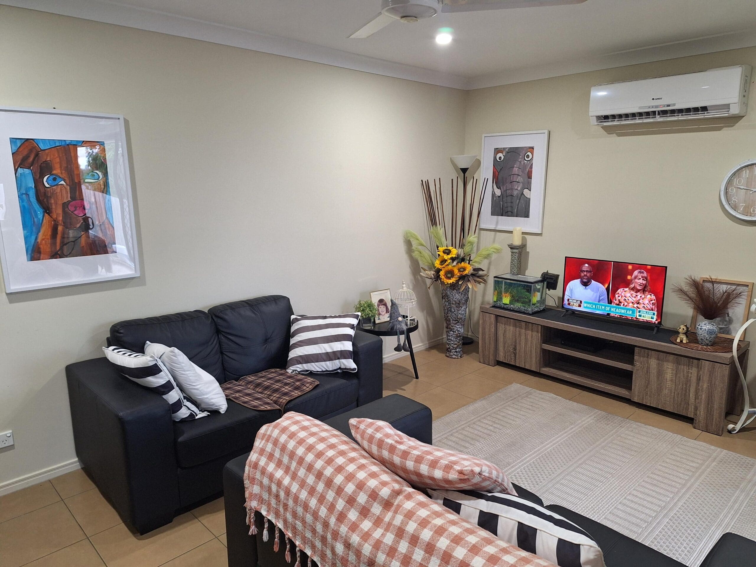 NDIS-compliant SIL in Brassall, Ipswich: cosy living room with supportive seating, media unit, and resident-focused decor, delivered by Australia’s leading disability accommodation provider.