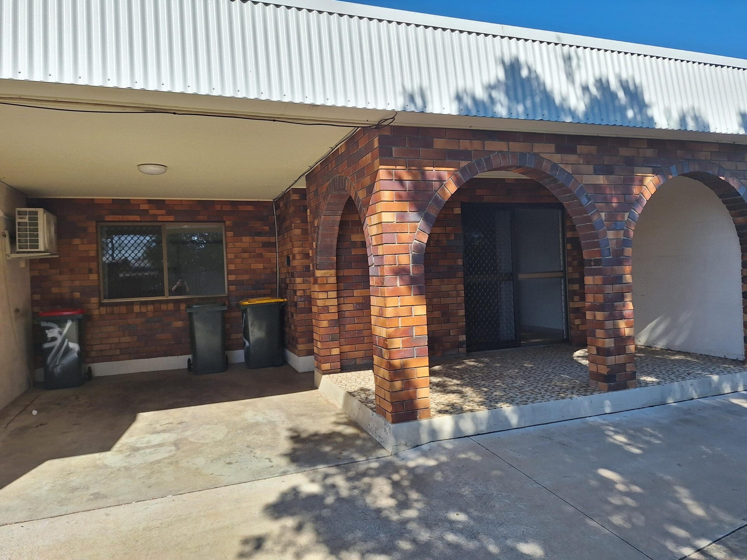 Private SIL unit living in a prime Millbank location with outdoor patio, white security door and covered entry by Australia's leading disability accommodation provider.