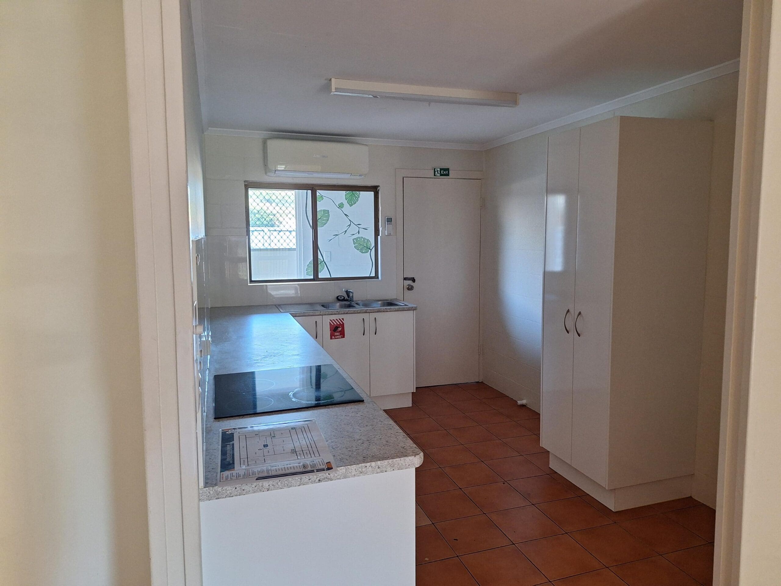 Private SIL unit living in a prime Millbank location with compact kitchen, built-in storage, tiled flooring and air conditioning by Australia's leading disability accommodation provider.