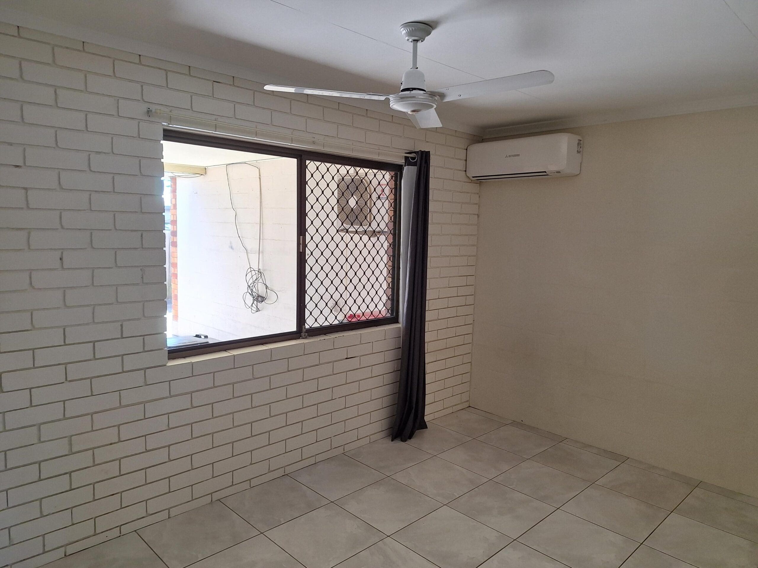 Private SIL unit living in a prime Millbank location with tiled room, ceiling fan, air conditioning and screened window by Australia's leading disability accommodation provider.