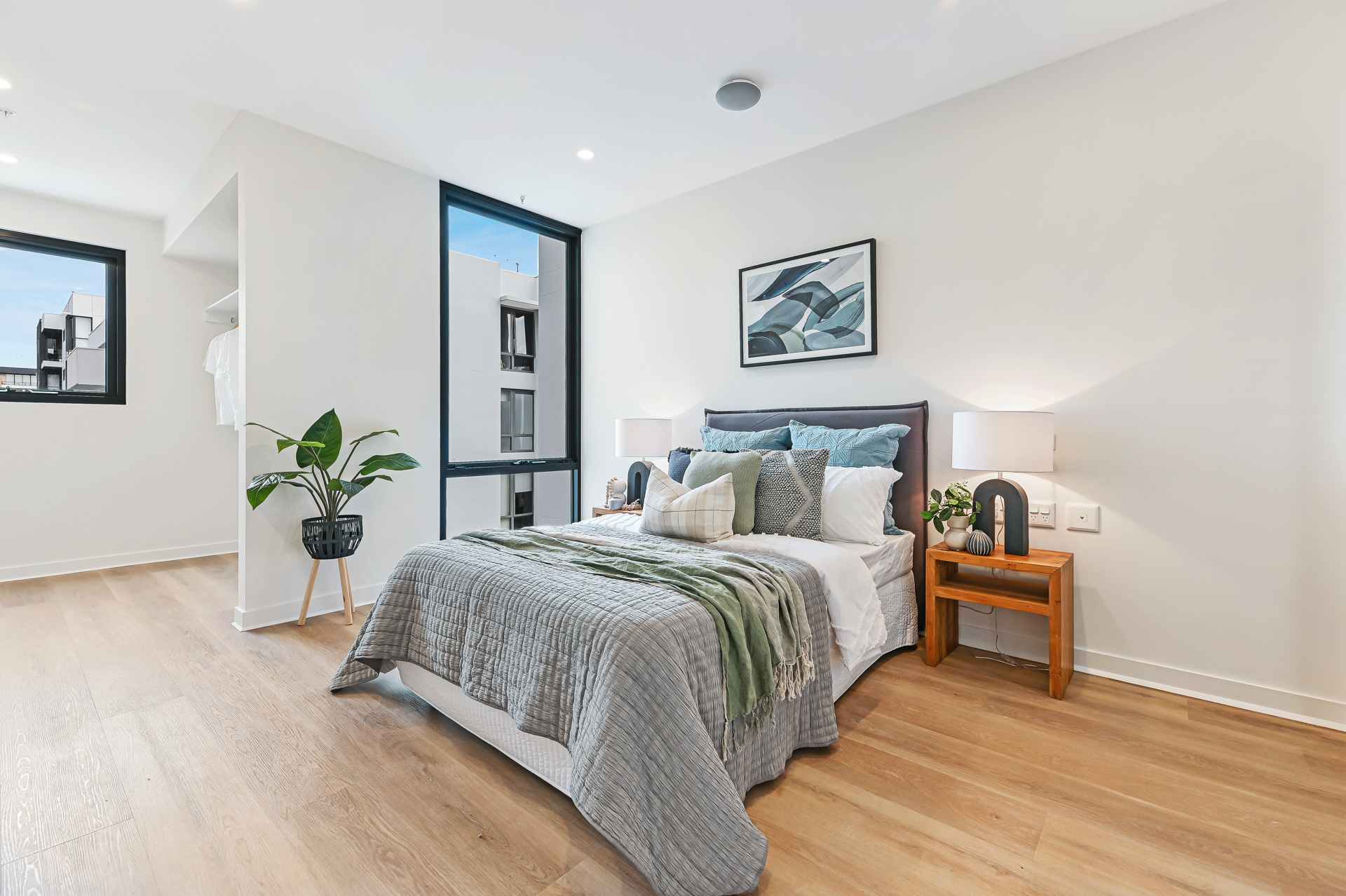 La Scala Avenue bedroom with double bed, bedside tables, indoor plant, wall art and timber-look flooring by Australia's leading disability accommodation provider.