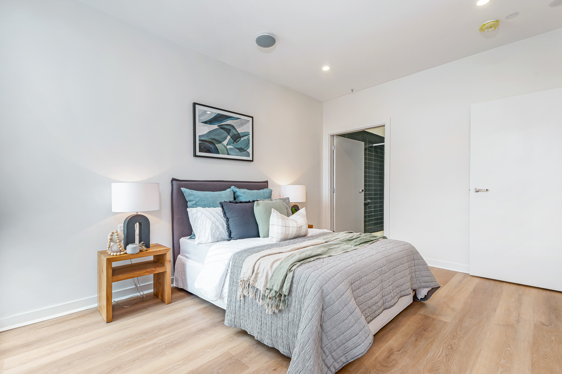 La Scala Avenue bedroom with double bed, bedside table, wall art, timber-look flooring and ensuite access by Australia's leading disability accommodation provider.