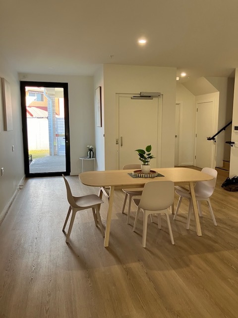 Villa 4, Fullarton, Dining and entry with dining table, four chairs, indoor plant and glass door by Australia's leading disability accommodation provider.