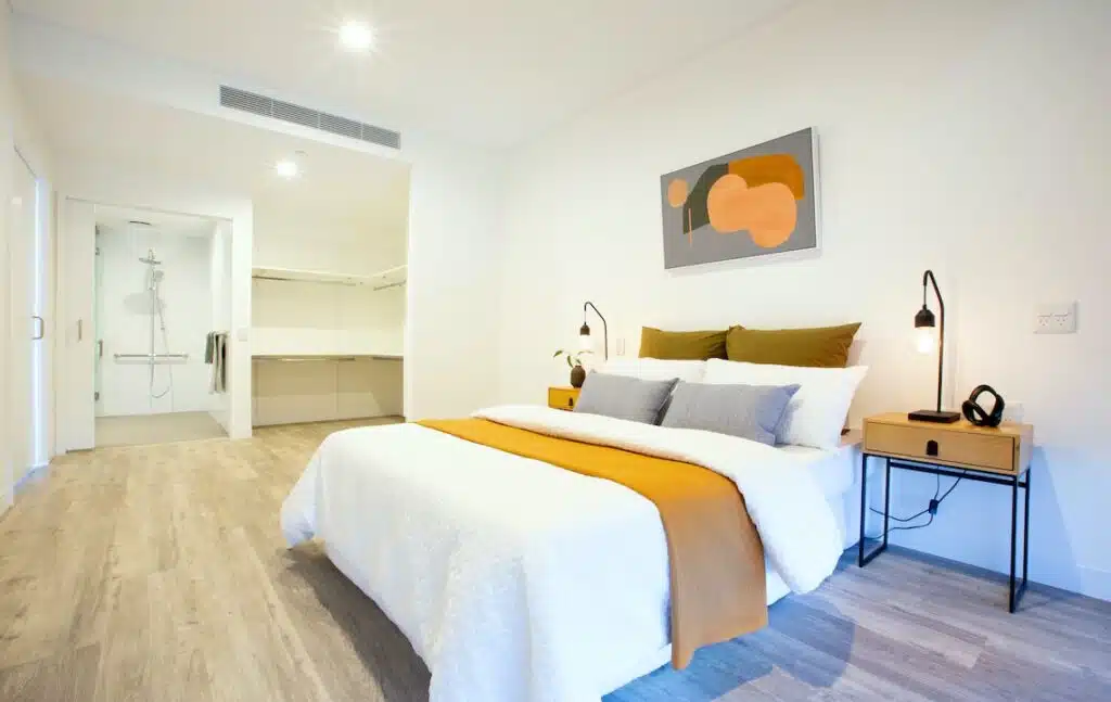 New SDA apartments in the heart of Joondalup with OSS, Grand Blvd, Joondalup bedroom with ensuite, walk-in robe and bedside tables by Australia's leading disability accommodation provider.