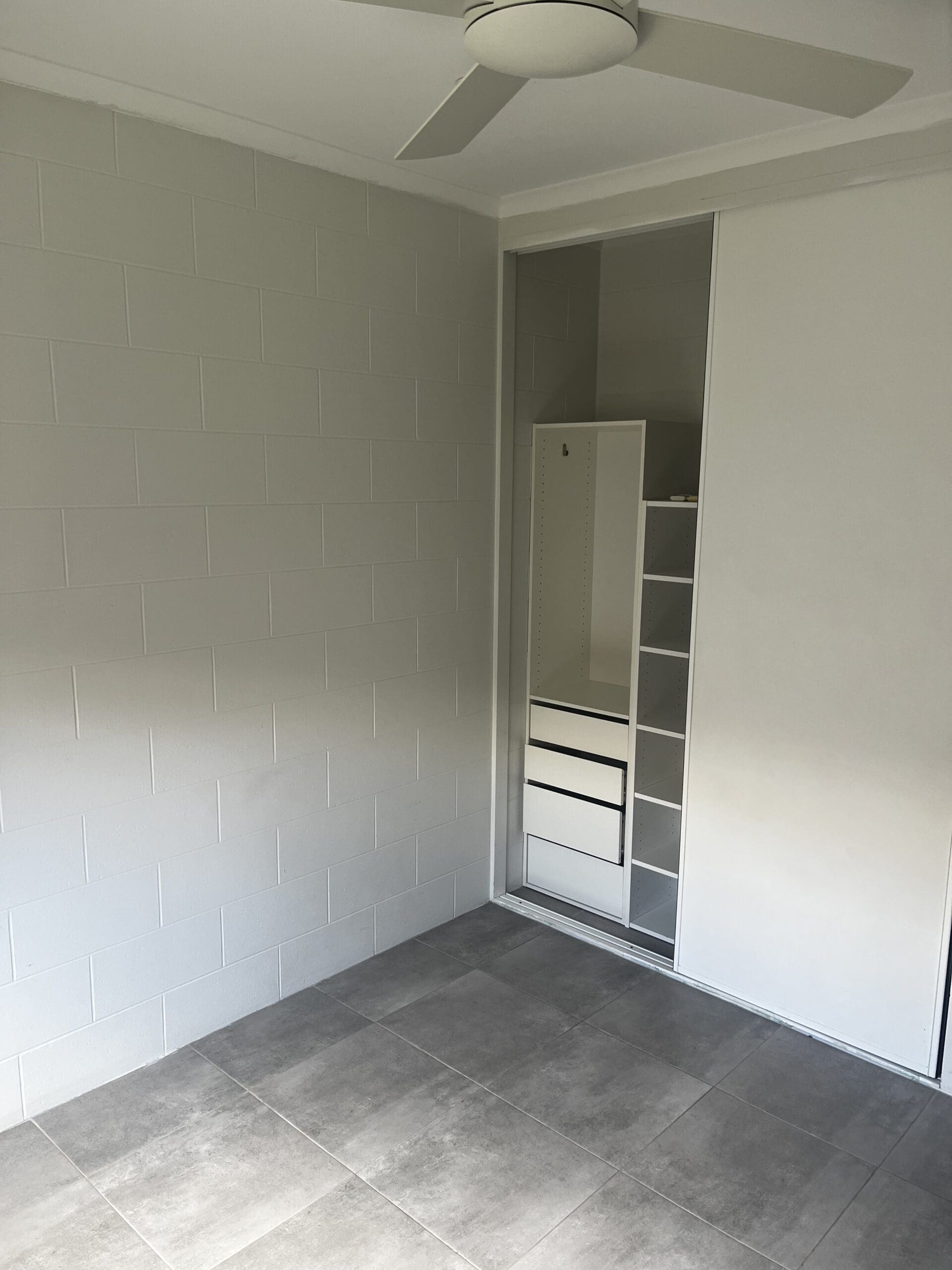 SIL Vacancy in Bentley Park, Cairns, Lorraine Close, Bentley Park bedroom with ceiling fan, tiled floor and built-in wardrobe by Australia's leading disability accommodation provider.