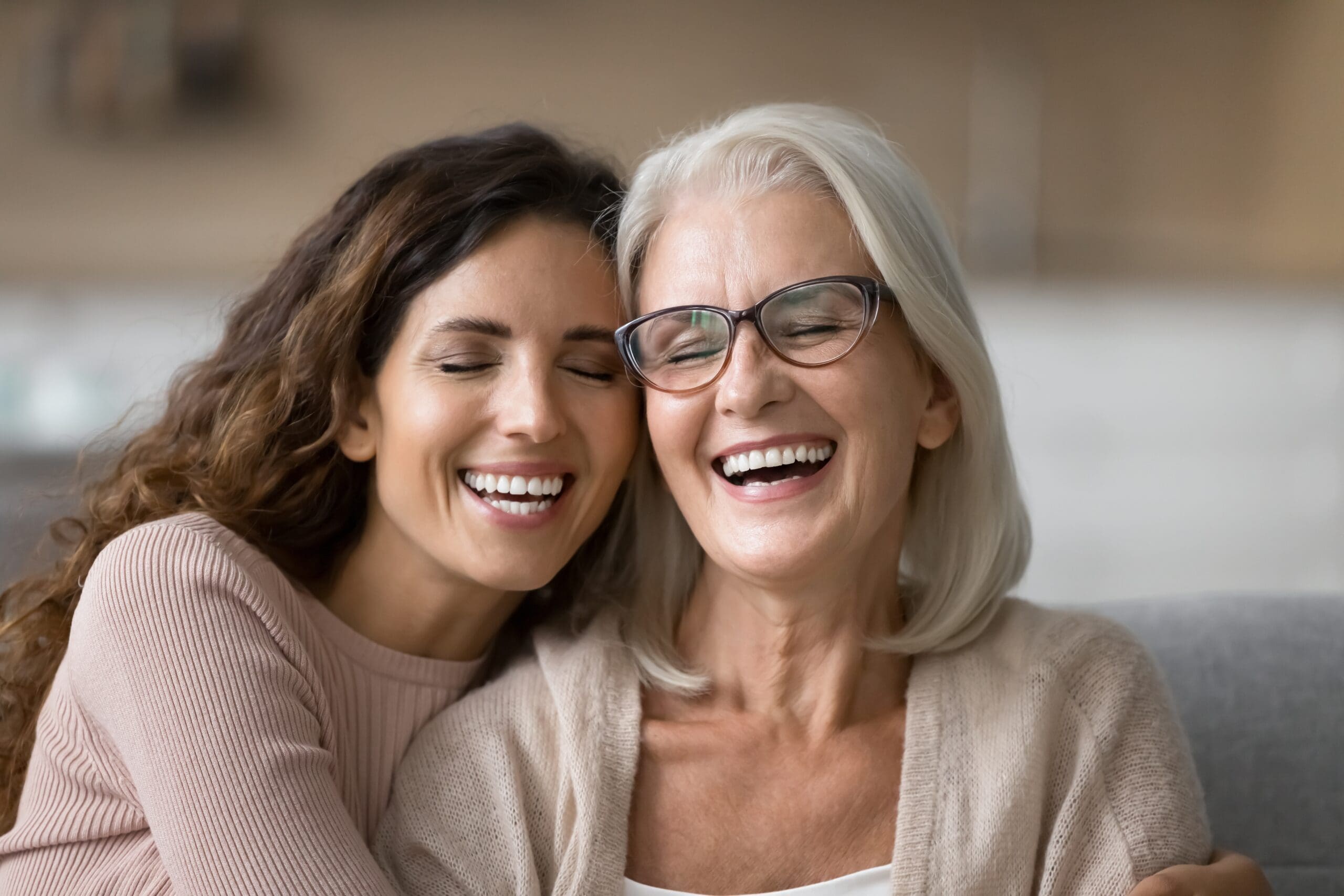 Elderly woman beside a younger woman smiling, navigating Support at Home paperwork.